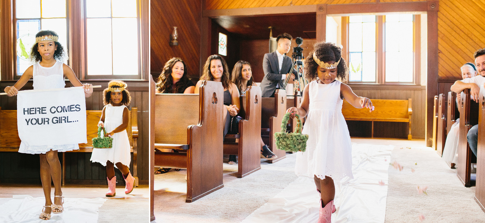 The flower girls walking down the aisle. 