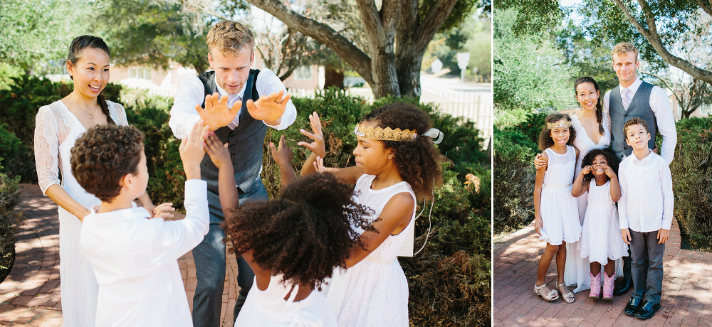 The bride and groom high-fiving the kids. 