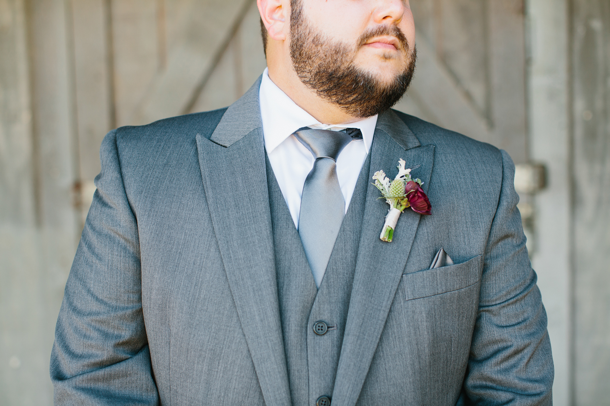 A close up of the groom's tie and boutonniere. 