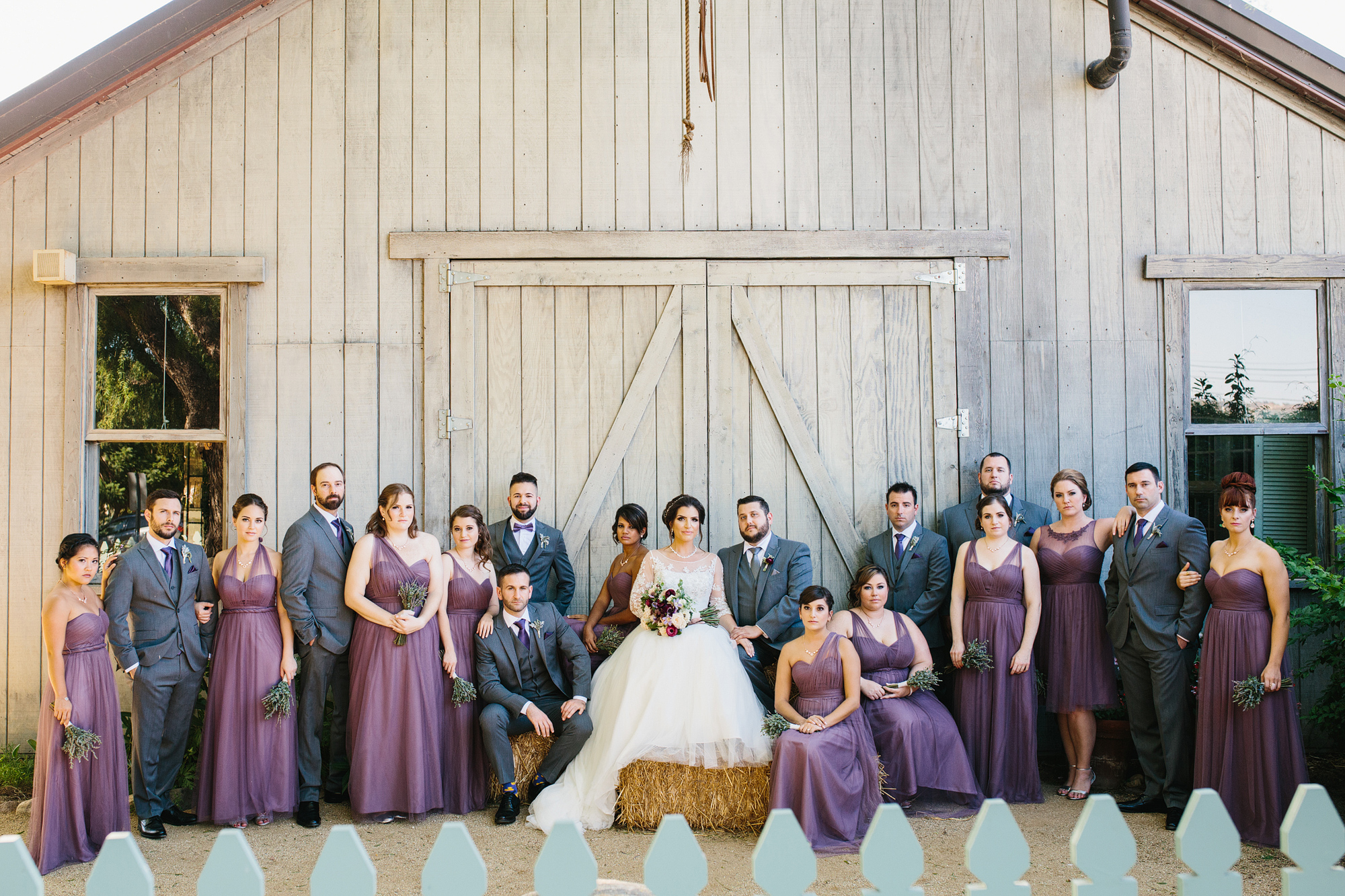 The full wedding party outside of the barn. 