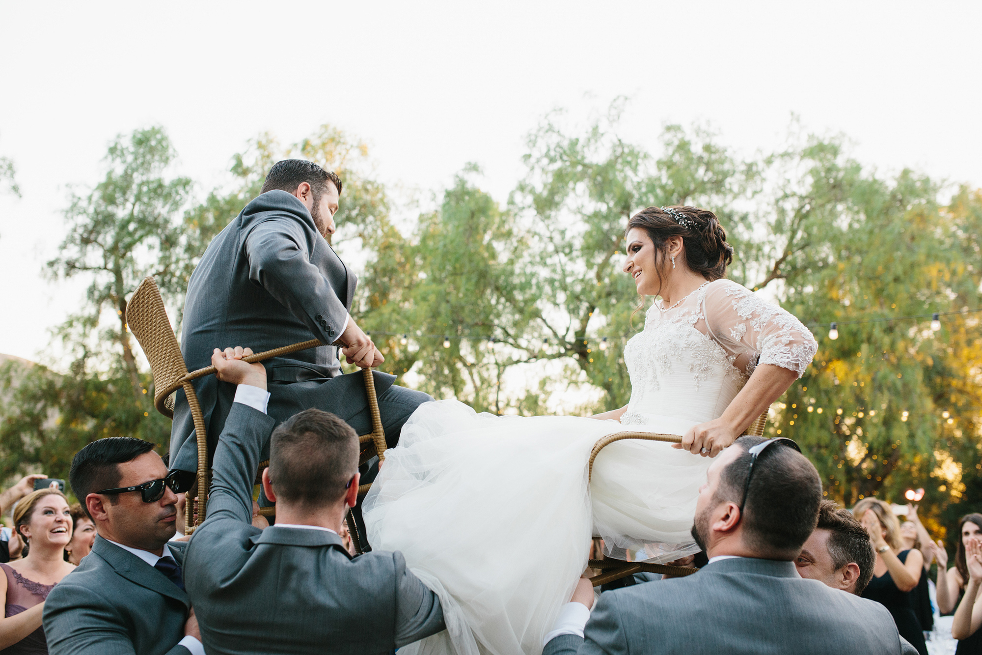 Steven and Samara being lifted on chairs during the hora. 