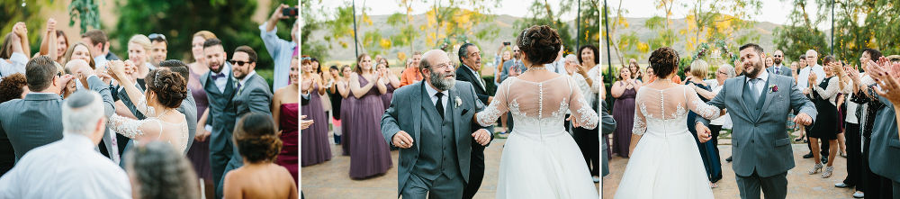 The couple dancing in the middle of the hora. 