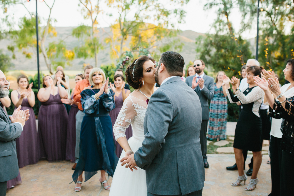 A sweet kiss during the hora. 