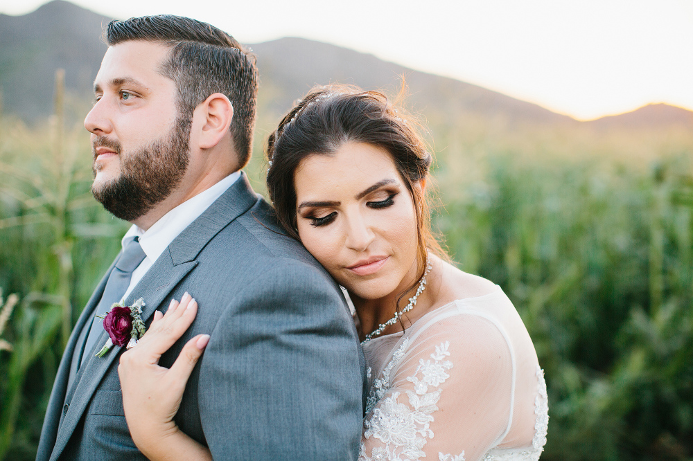 A sweet photo of the bride hugging the groom. 