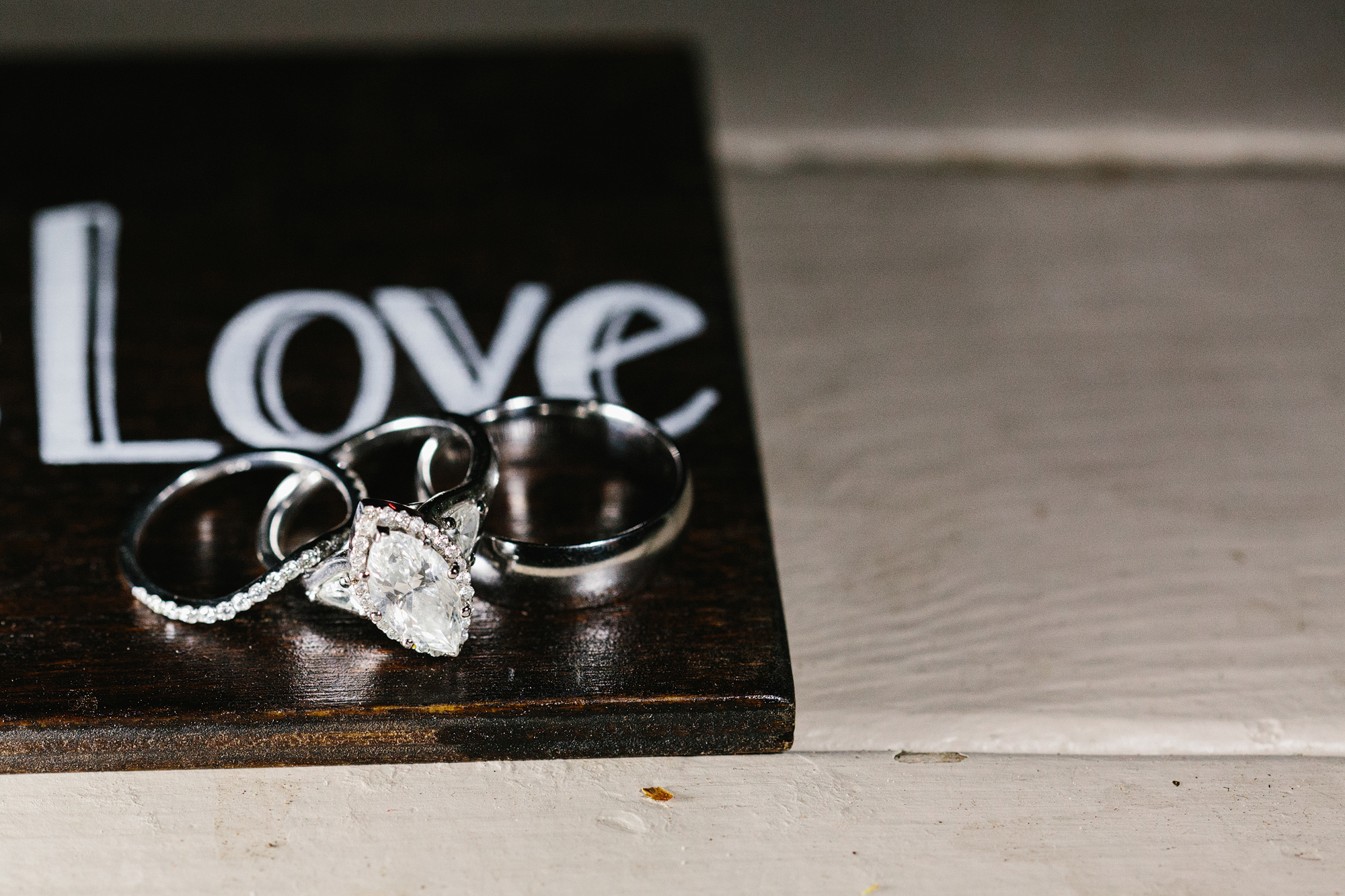The couple's wedding rings on a Love sign. 
