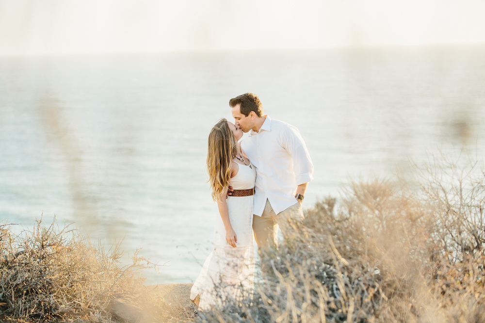 A cute photo of the couple kissing. 