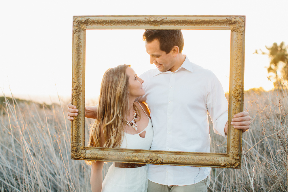 The couple brought a gold frame prop. 