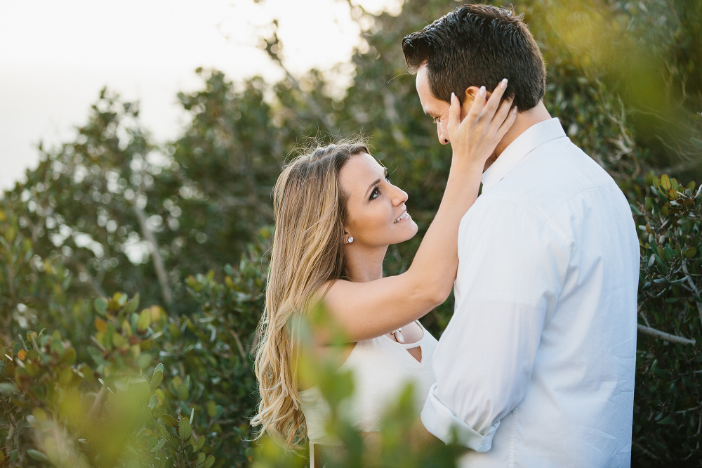 A beautiful photo of Vanessa and Steven by green trees. 