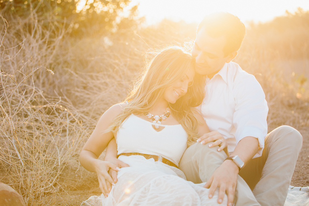 A sweet photo of the couple sitting on a path. 