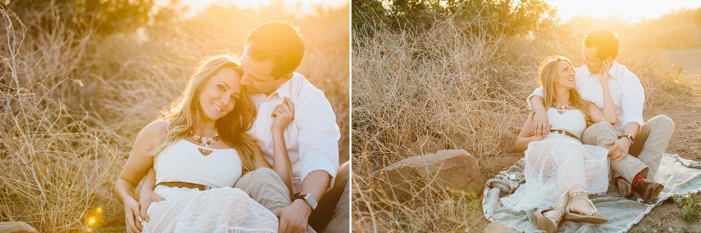 The couple sitting on a blanket at sunset. 