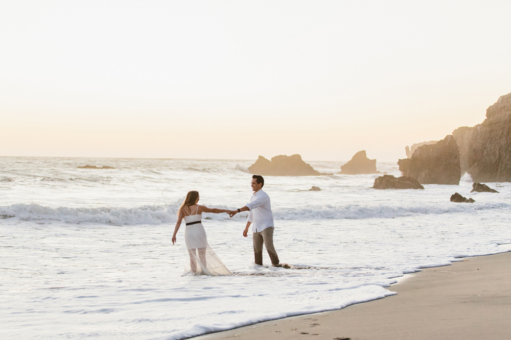 The couple dancing in the water. 