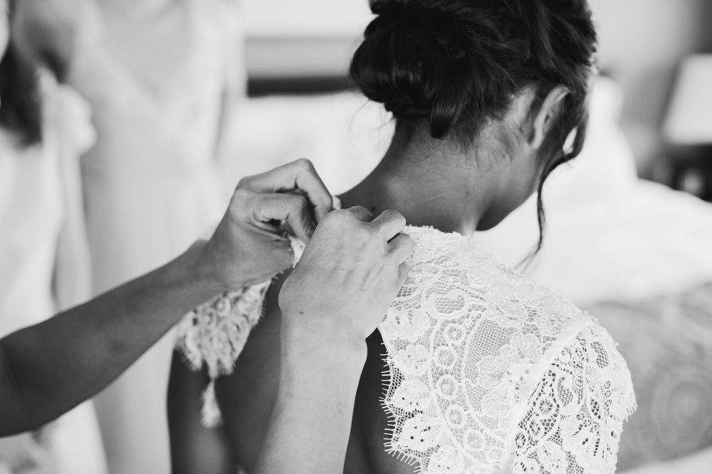 The bride getting in her wedding dress. 