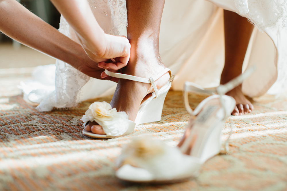 The bride putting on her shoes. 