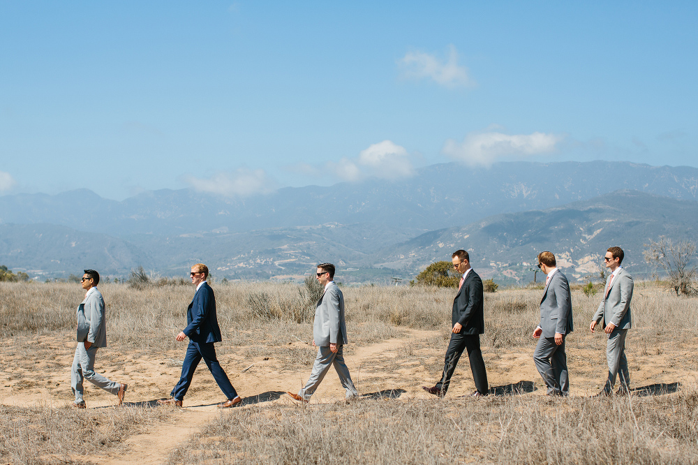The groom and groomsmen walking in the bluffs. 