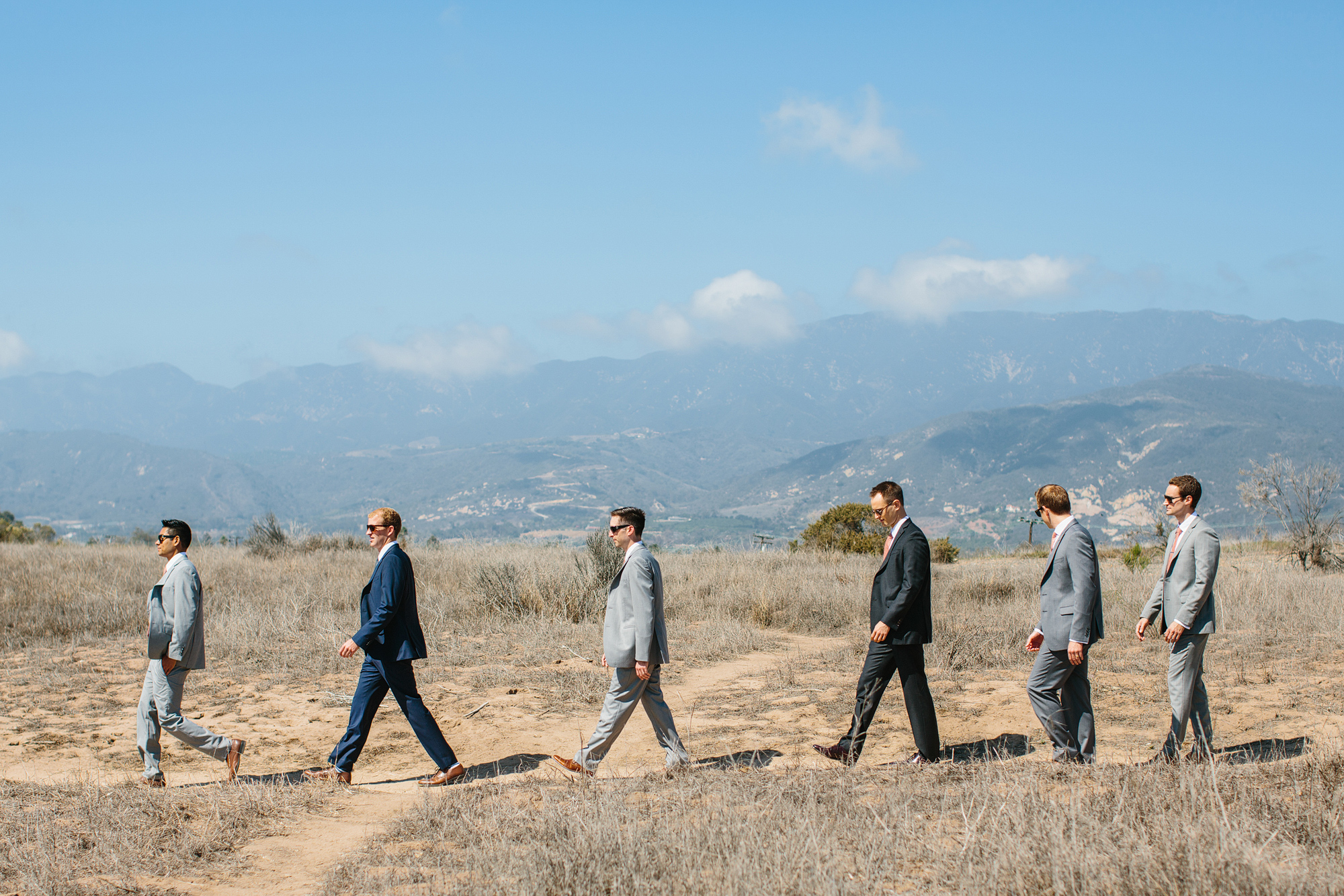 The groom and groomsmen walking in the bluffs. 