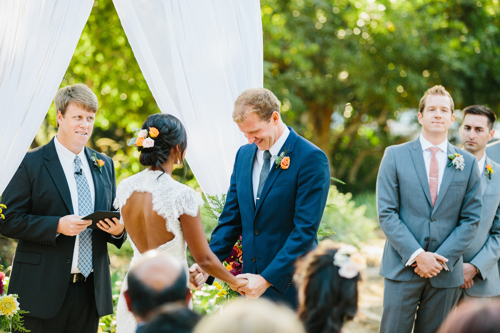 The groom laughing during the ceremony. 