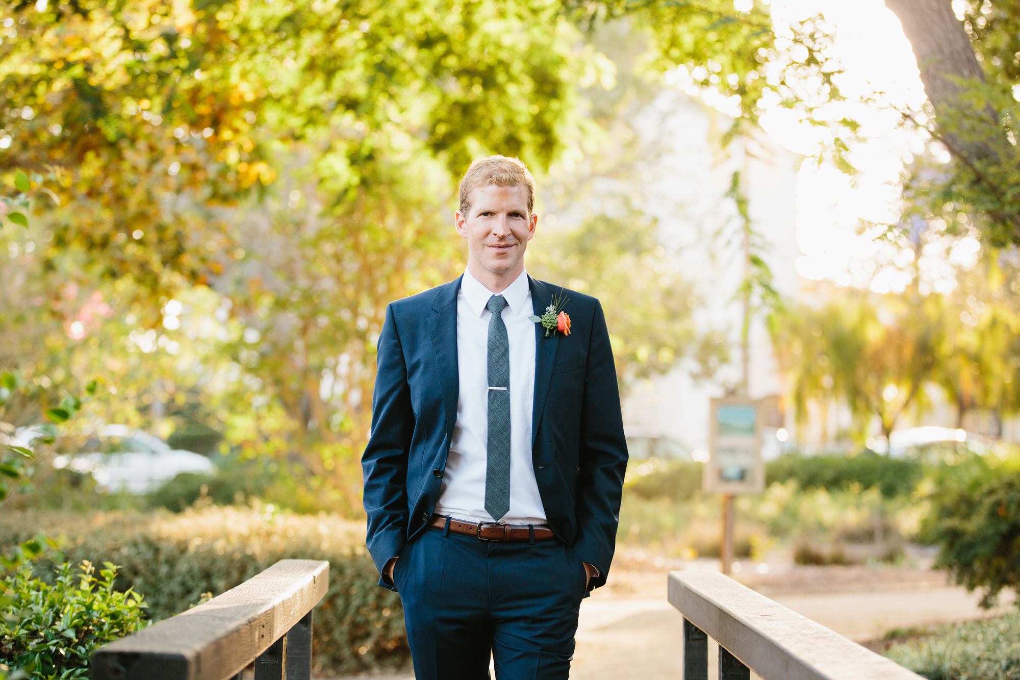 A portrait of the groom on a bridge. 
