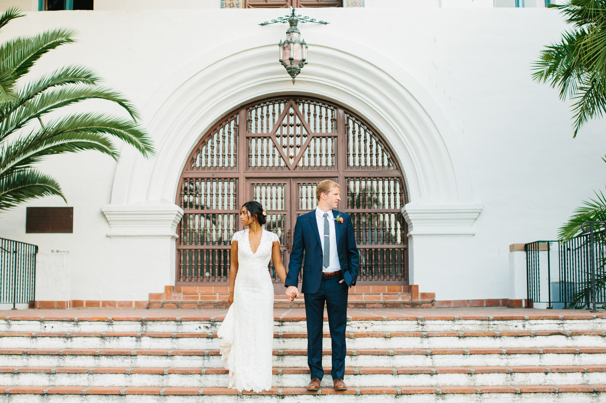 The couple standing on brick steps. 