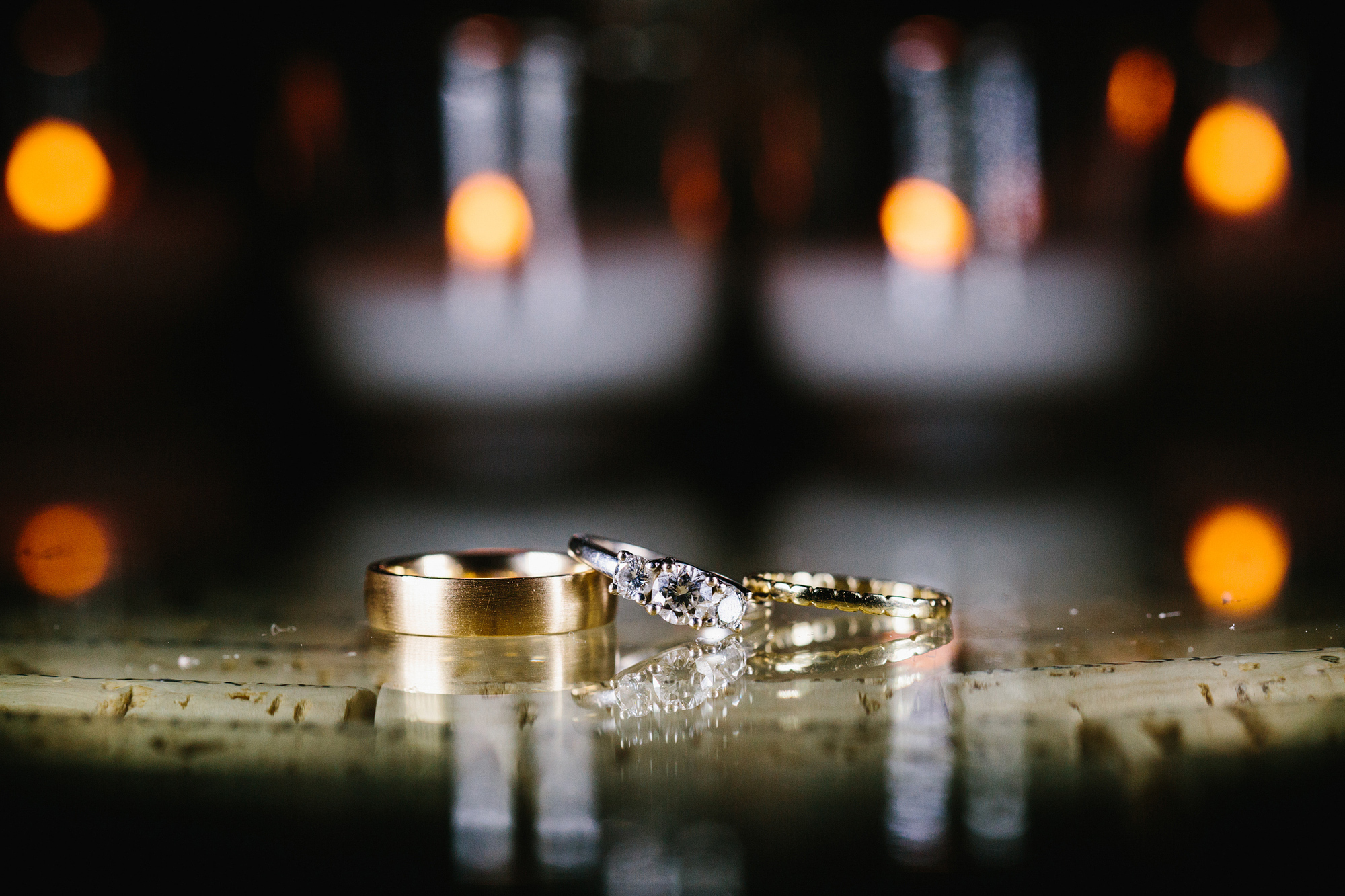 The wedding rings on a wine cork table. 