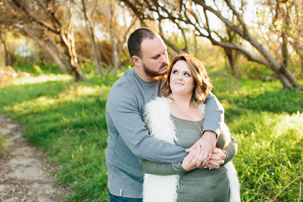 Jason and Amanda surrounded by fields and trees. 