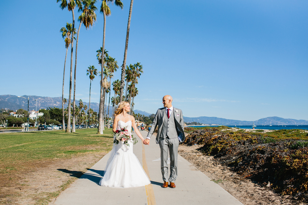 The couple standing on the bike path on the beach. 