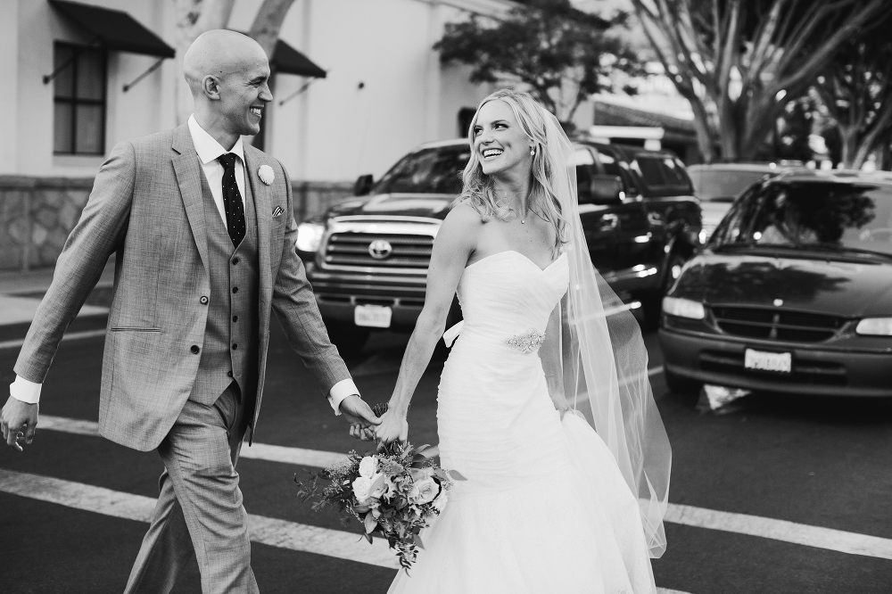 The bride and groom crossing the street. 