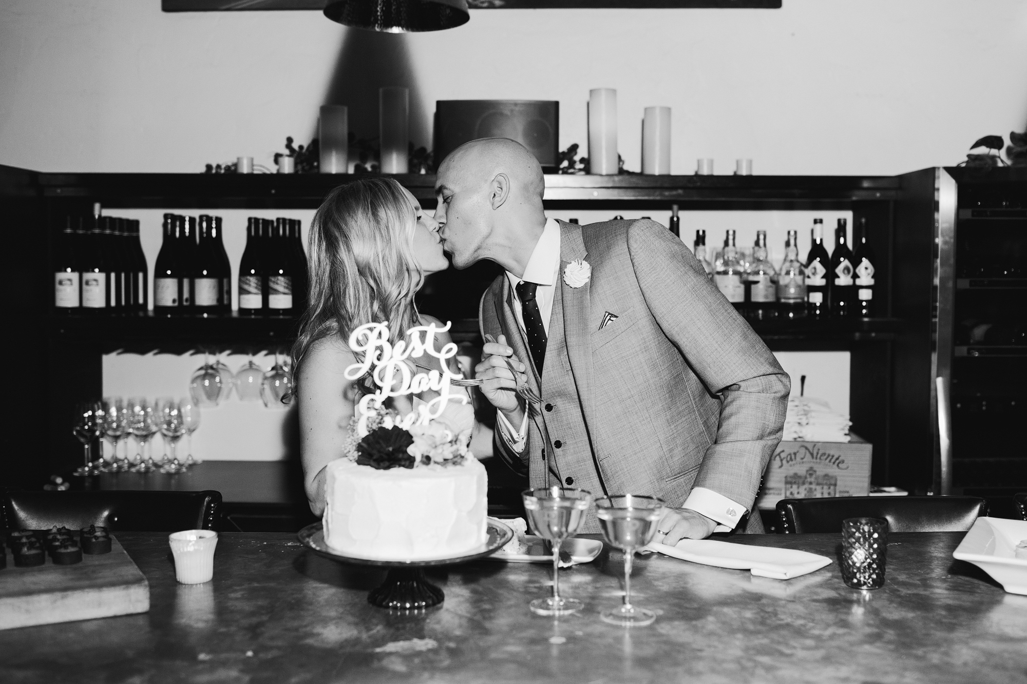 A sweet photo of the couple kissing after cake cutting. 
