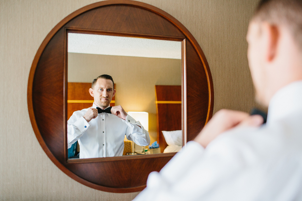 Shawn straightening his bow tie in the mirror. 