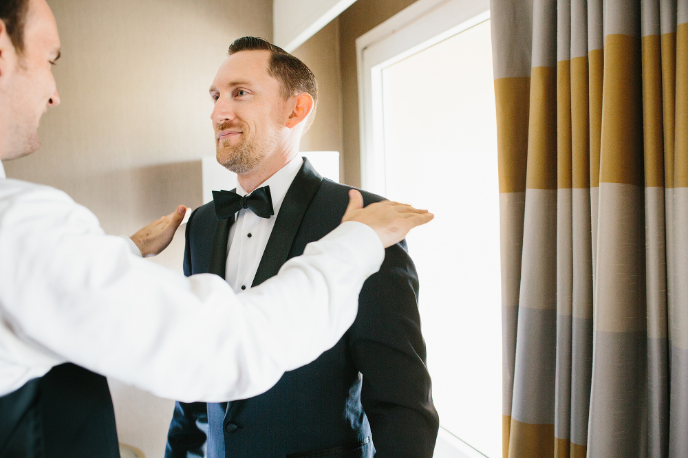 A groomsman helping Shawn get ready. 