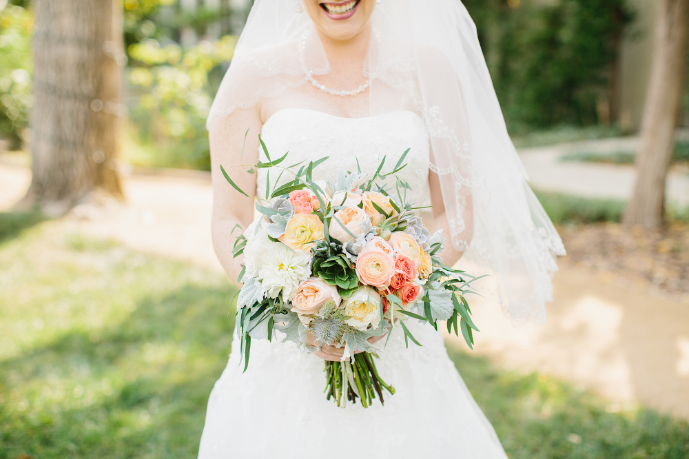 The bride holding her blush peach bouquet. 