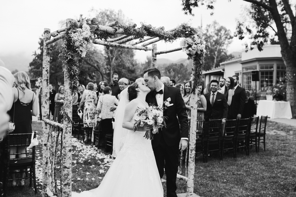 A sweet kiss at the end of the aisle. 
