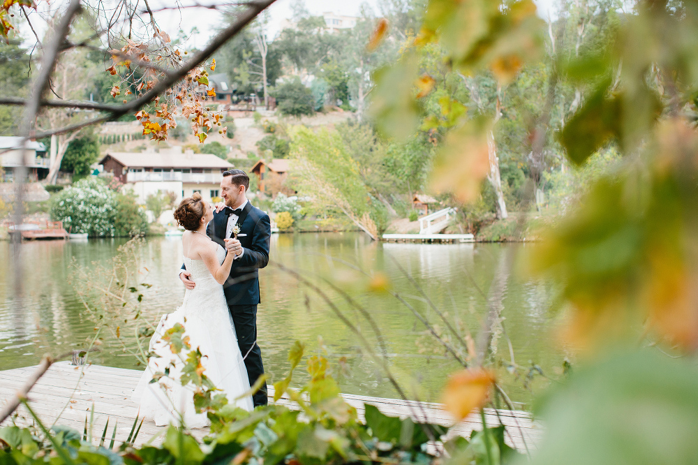 A photo through the trees of the couple. 