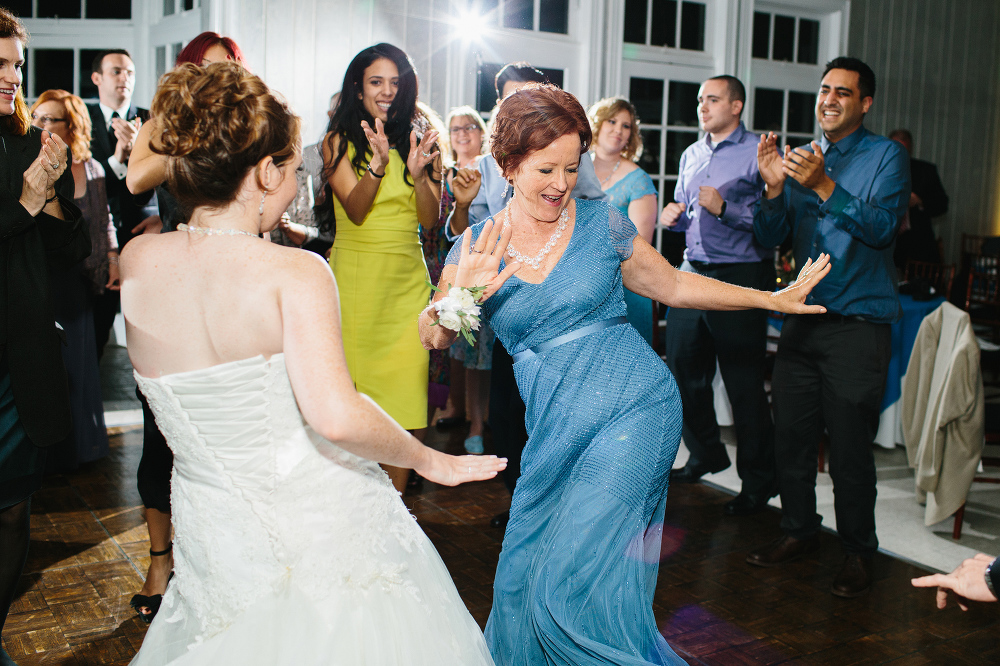 The bride and her mom dancing together. 