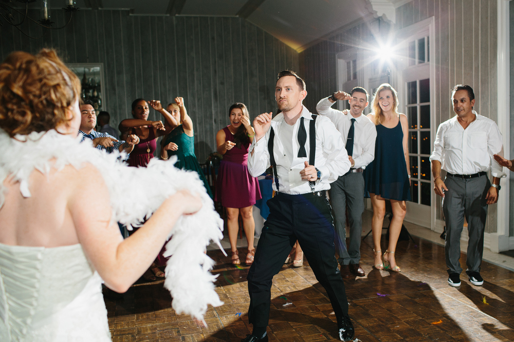 The groom dancing in the center of all the guests. 