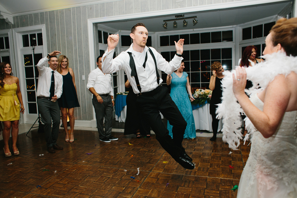 The groom jumping in front of the bride. 