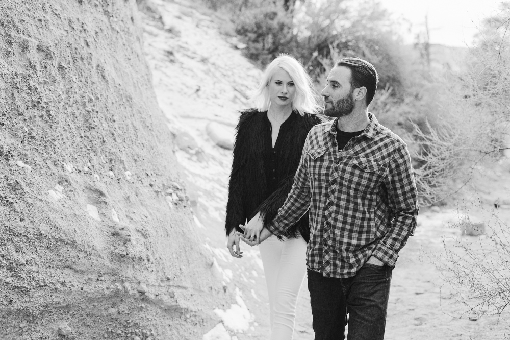 A beautiful black and white photo of Matt walking in front of Julia. 