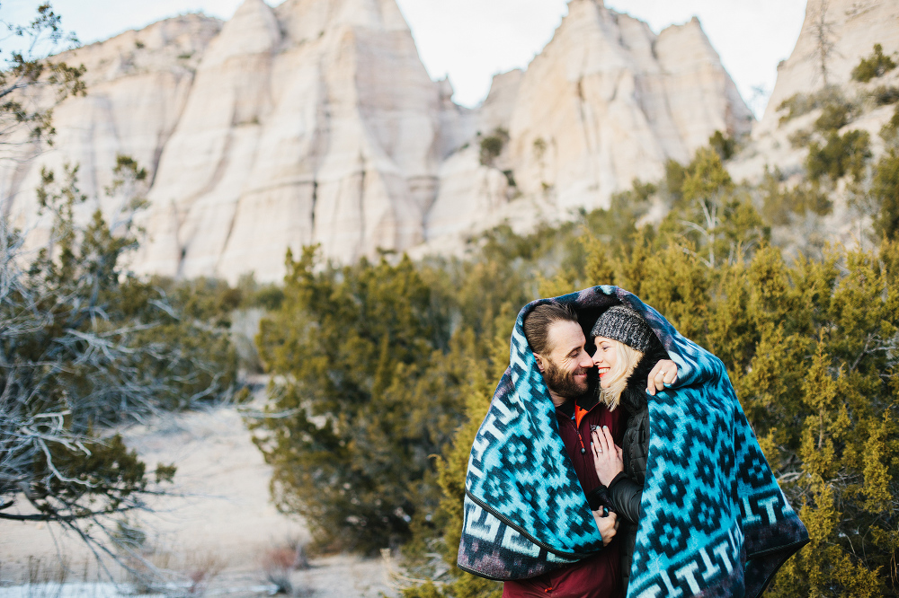 A sweet photo of the couple wrapped in a blanket. 