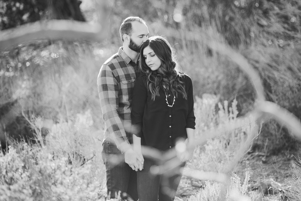 A beautiful black and white photo of the couple in the fields. 