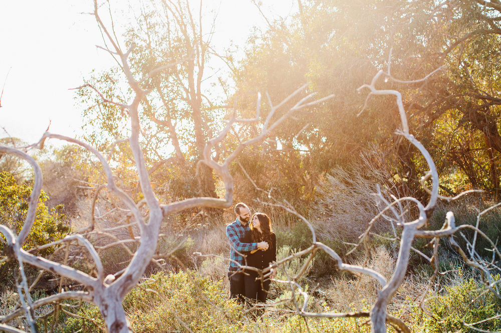 A gorgeous photo of the couple through the trees. 