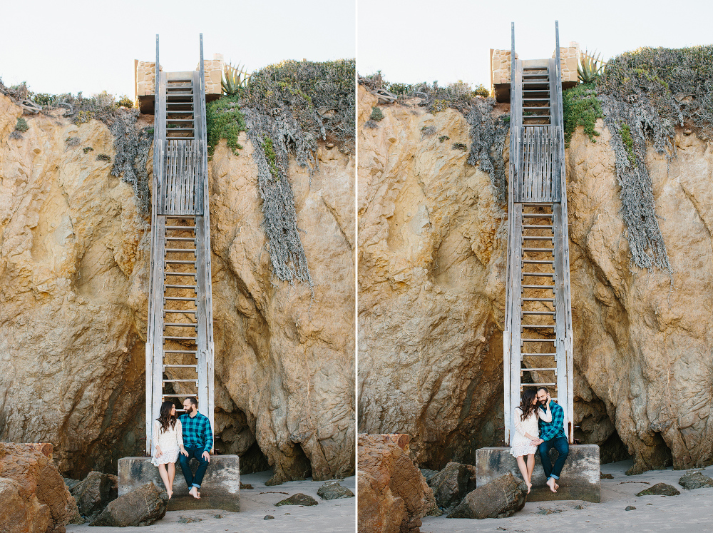 The couple sitting in front of a tall staircase. 