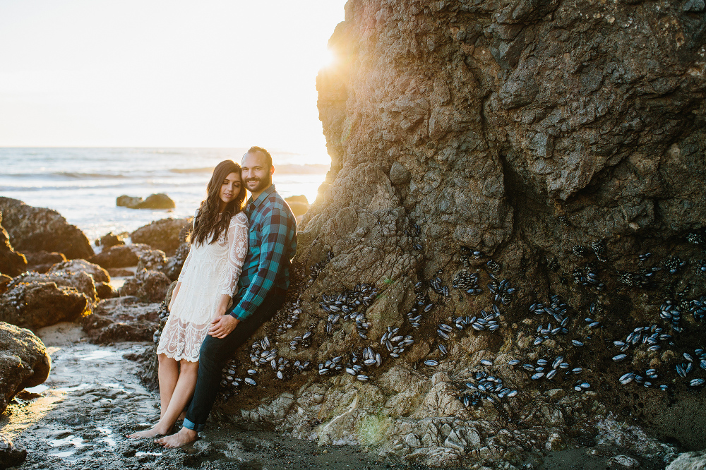 The couple leaning on a rock. 