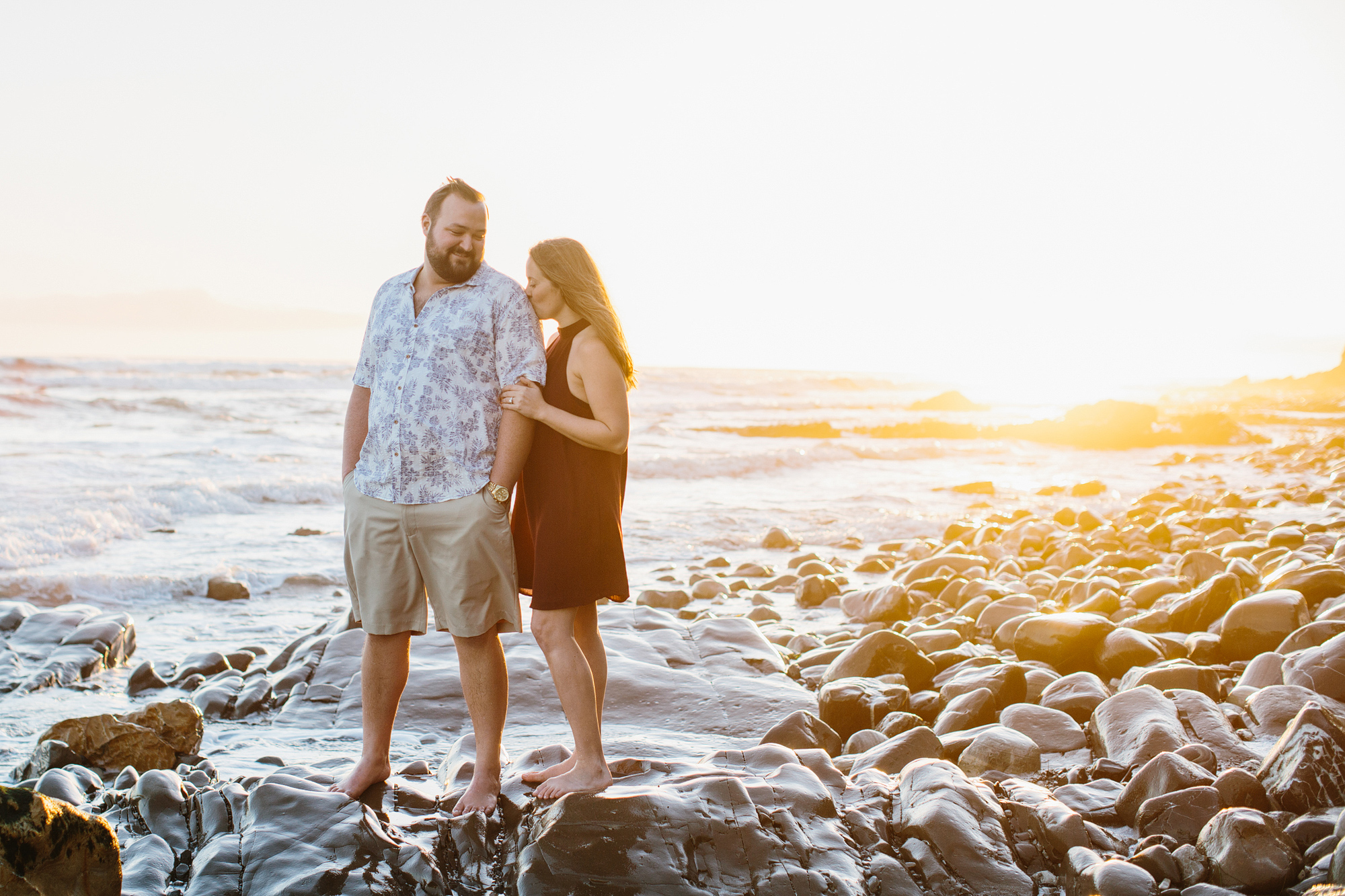 An adorable photo of the couple on a rock. 