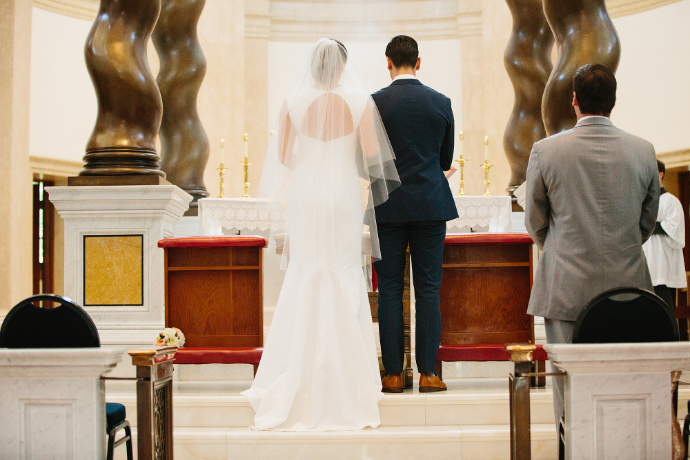 The bride and groom standing at the altar. 