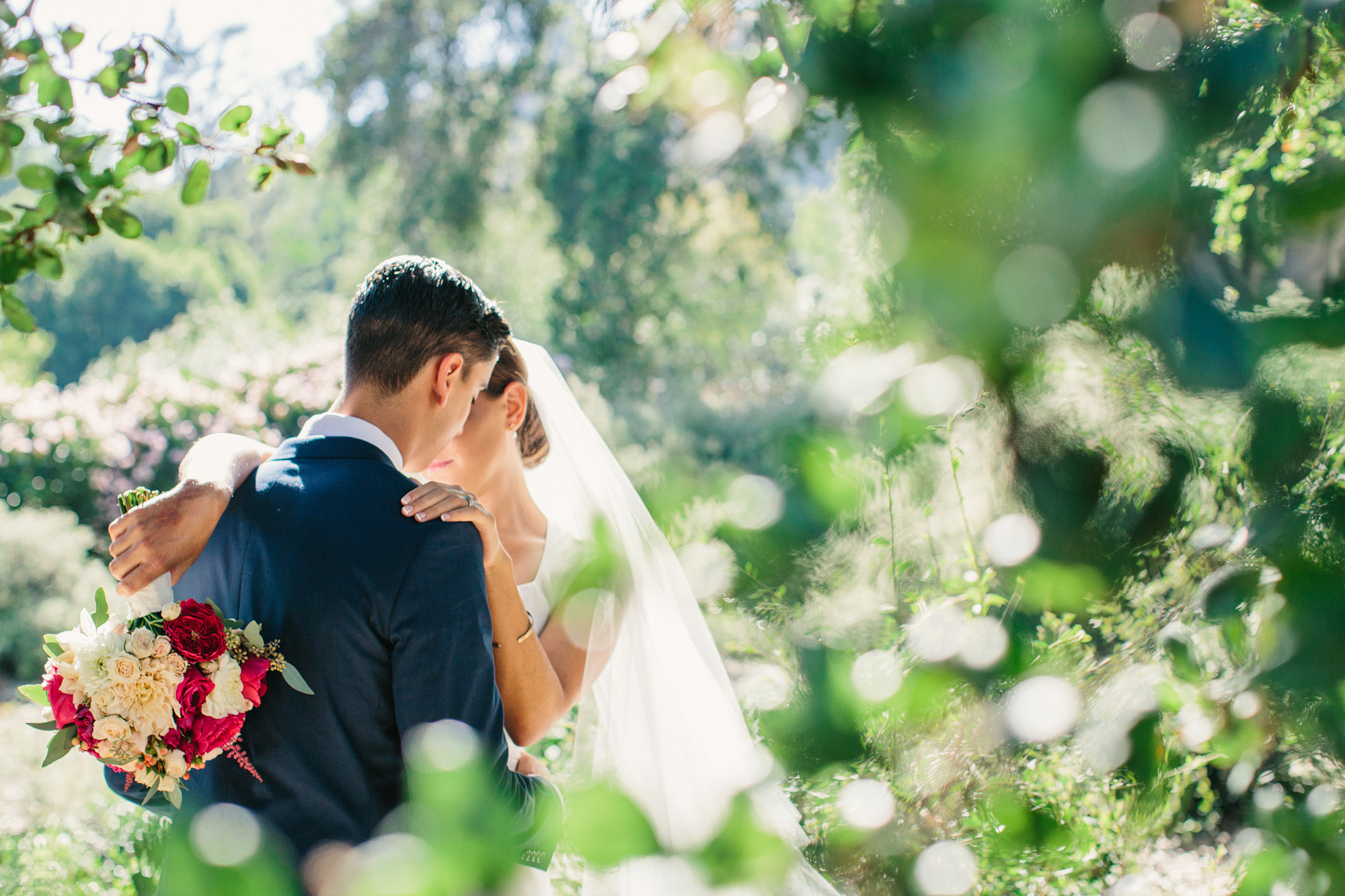 A photo of the couple through the trees. 