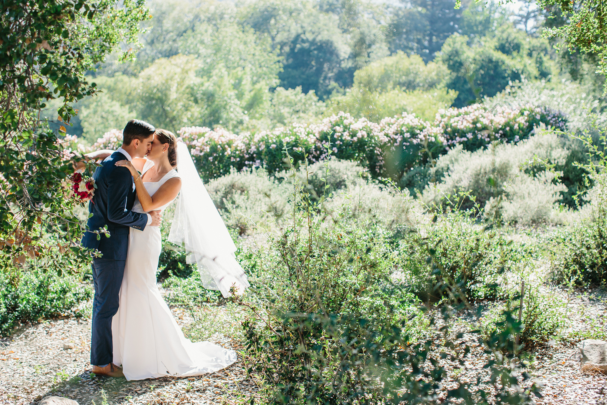 A beautiful photo with the bride and groom with a lot of greenery. 