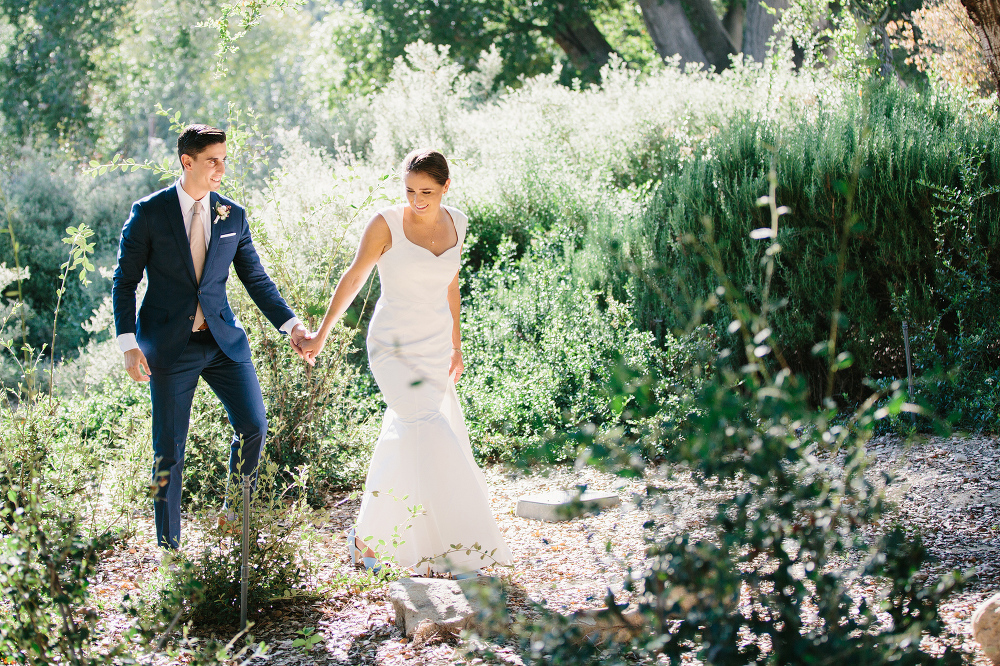 Hilary and Andrew holding hands walking together. 