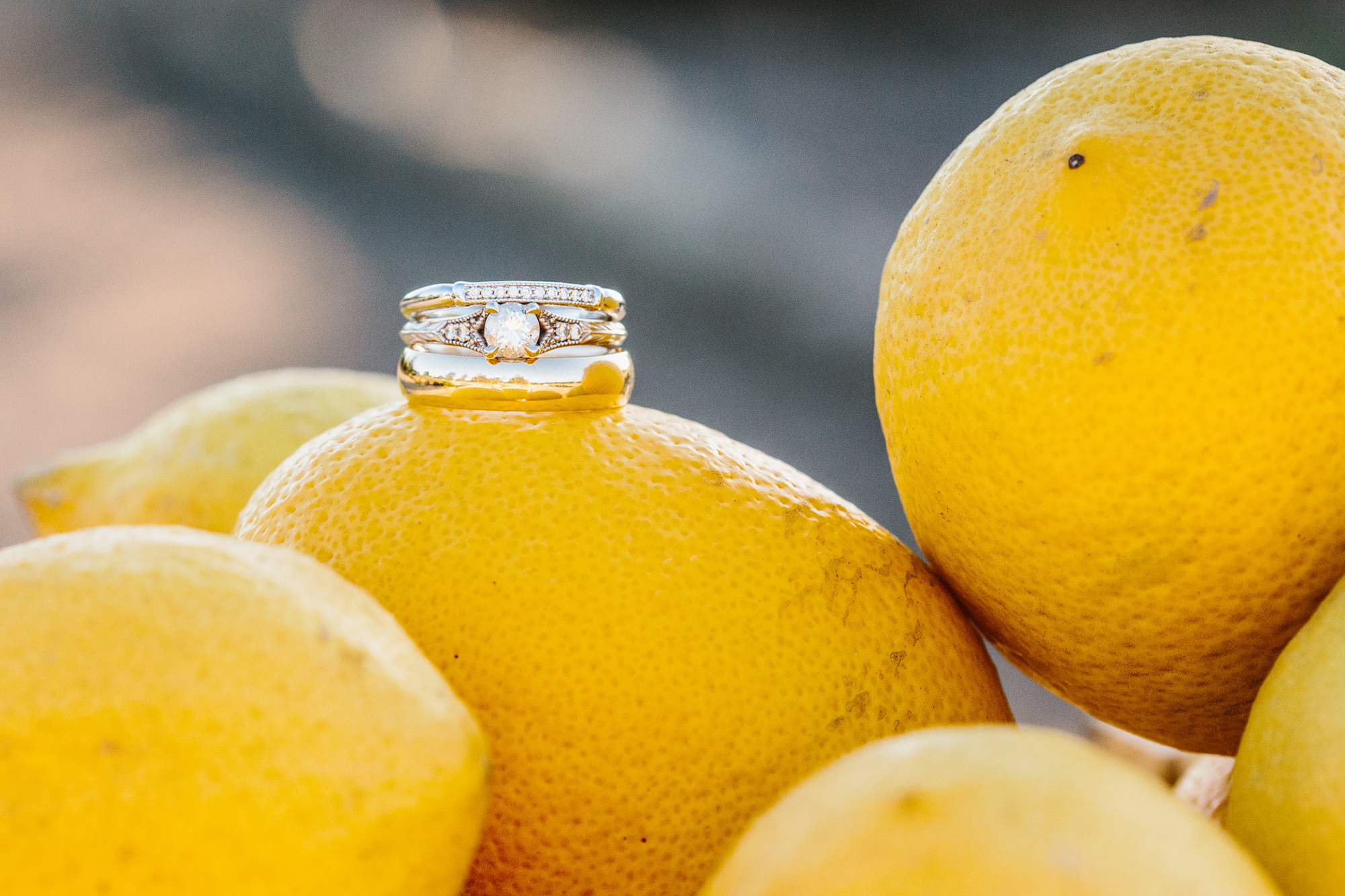 The wedding rings on a stack of lemons. 