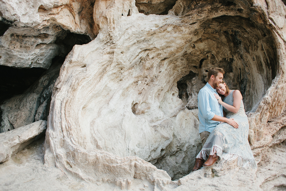 Madie and Matthew in front of a rock cave. 