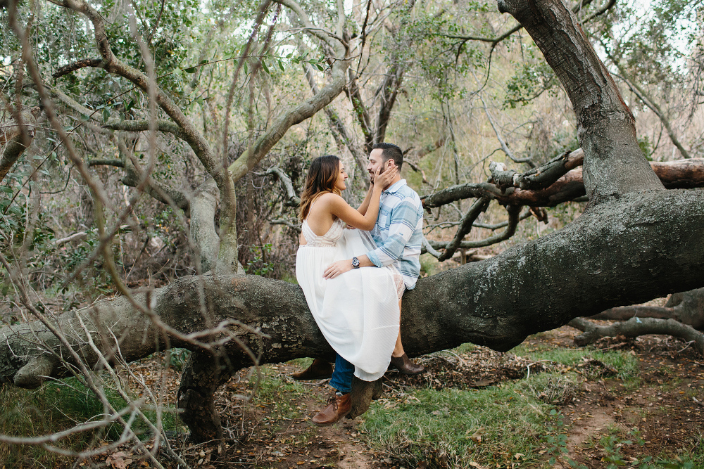 Kailie and Michael sitting on a tree branch. 