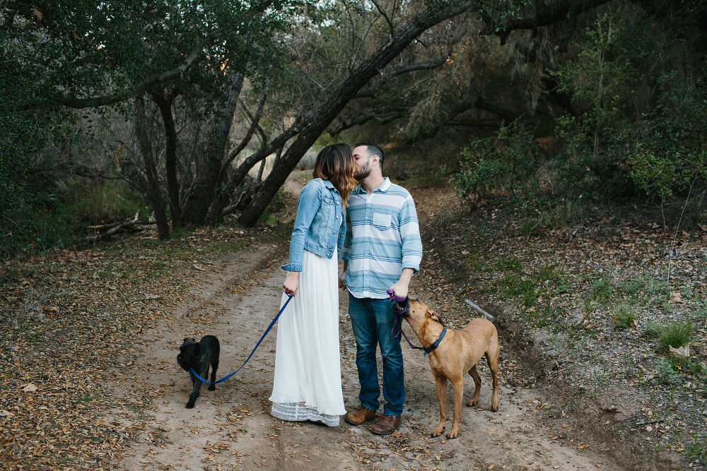 The couple on a dirt path with their dogs. 
